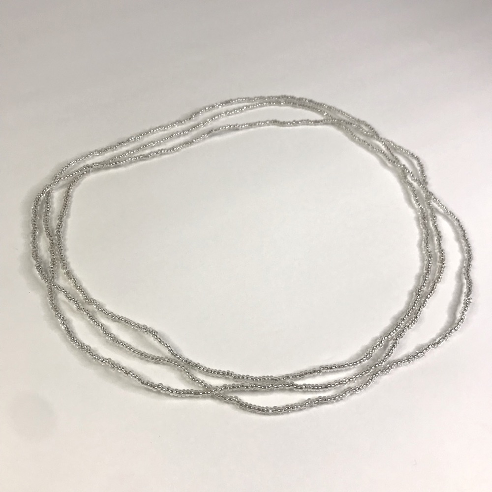 Clear small beaded necklace with an elastic cord in the middle
